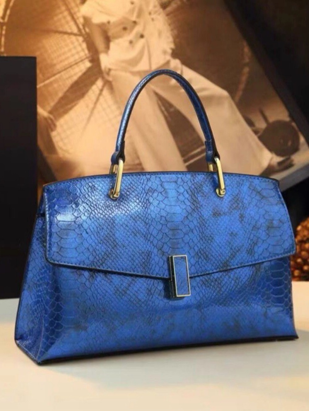 A Classy Chic Boutique Blue Textured Satchel with Gold Accents.
